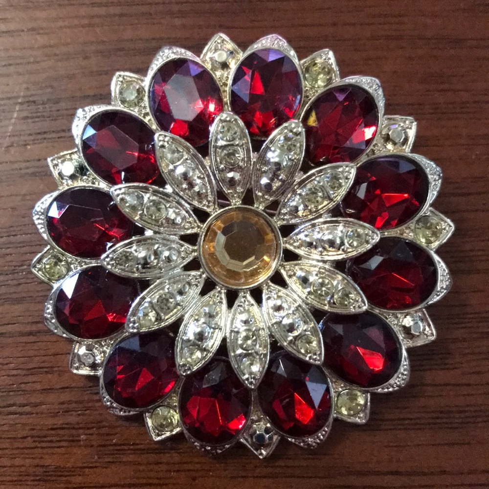 Gold tone pin with red and gold crystals